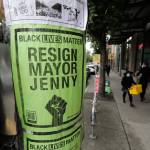 A poster calls for the resignation of Seattle Mayor Jenny Durkan near an entrance to what has been named the Capitol Hill Occupied Protest zone in Seattle. Protesters have taken over several blocks near downtown Seattle after officers withdrew from a police station in the area following violent confrontations. (AP Photo/Ted S. Warren)