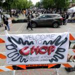 A sign reads Welcome to CHOP, on Sunday inside what has been named the Capitol Hill Occupied Protest zone in Seattle. The name is a change from CHAZ (Capitol Hill Autonomous Zone) that was used earlier in the week. (AP Photo/Ted S. Warren)