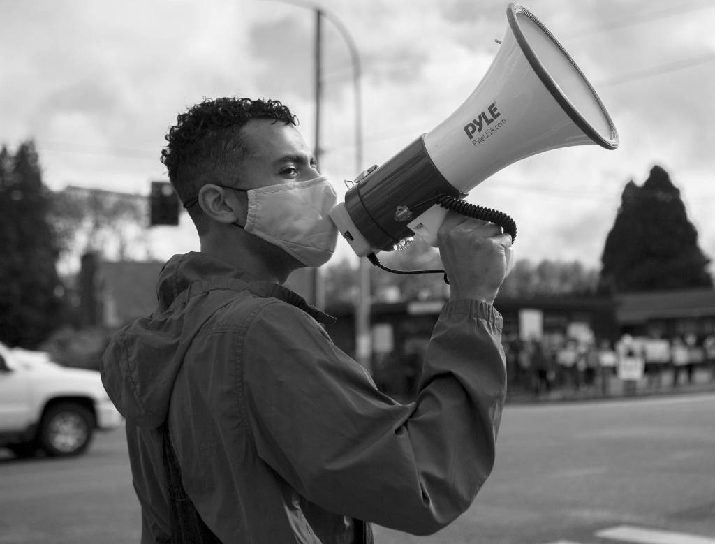 Drake Wilson, one of the organizers of a peaceful protest in Snohomish, leads the protesters in a chant from the corner of Second Street and Avenue D on June 12 in Snohomish. (Olivia Vanni / The Herald)