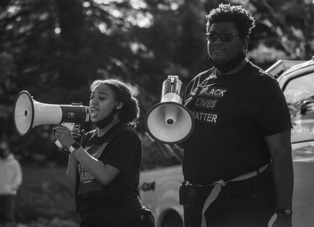 Jordyn Porea (left) and Alex Callaway (right), organizers of a peaceful protest on Mukilteo, lead protesters in a down Mukilteo Speedway on June 7 in Mukilteo. (Olivia Vanni / The Herald)