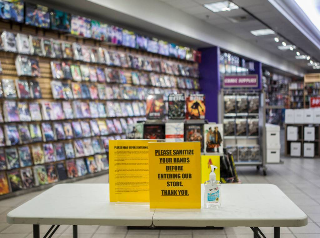 A table with hand sanitizer at Phantom Zone Comics at Everett Mall. (Olivia Vanni / The Herald)