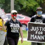 A protester holds a sign that reads Justice for Manny on June 5 in Tacoma during a protest against police brutality and the death of George Floyd, a black man who died after being restrained by Minneapolis police officers on May 25. (AP Photo/Ted S. Warren)