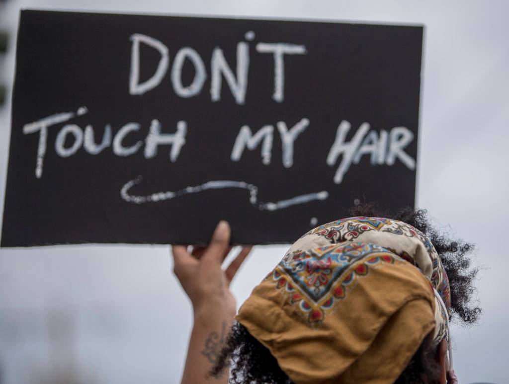 Mahllie Beck holds up a sign that sats dont touch my hair during a Juneteenth protest on Friday, June 19, 2020 in Snohomish, Wa. (Olivia Vanni / The Herald)