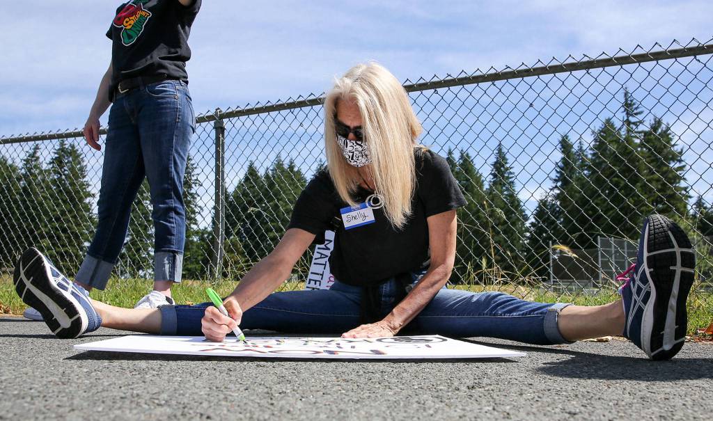 Hundreds of marchers took part in a Juneteenth Black Lives Matter march from College Place Middle School to the Edmonds School District headquarters Friday in Lynnwood. (Kevin Clark / The Herald)