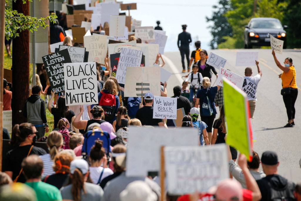 Hundreds of marchers took part in a Juneteenth Black Lives Matter march from College Place Middle School to the Edmonds School District headquarters Friday in Lynnwood. (Kevin Clark / The Herald)