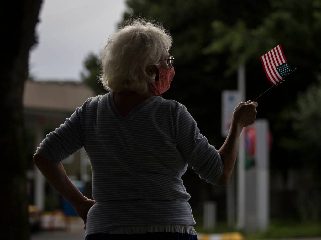 Andrea Moore waves a flag in support of protesters on Friday, June 19, 2020 in Snohomish, Wa. (Olivia Vanni / The Herald)