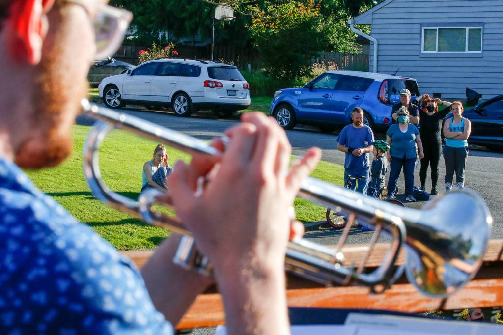 Jackson Cruz plays from Jake Bergevins deck as neighbors gather to listen Thursday afternoon in Everett on June 25, 2020. (Kevin Clark / The Herald)