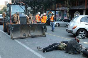 Demonstrators resist as crews arrive at Seattle protest zone