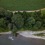 Tulalip Tribes rotary screw trap, used to trap salmon smolt for population monitoring, is seen July 22 tethered along the riverfront property the Tribes are set to purchase from PCC Farmland Trust in Monroe. (Olivia Vanni / The Herald)
