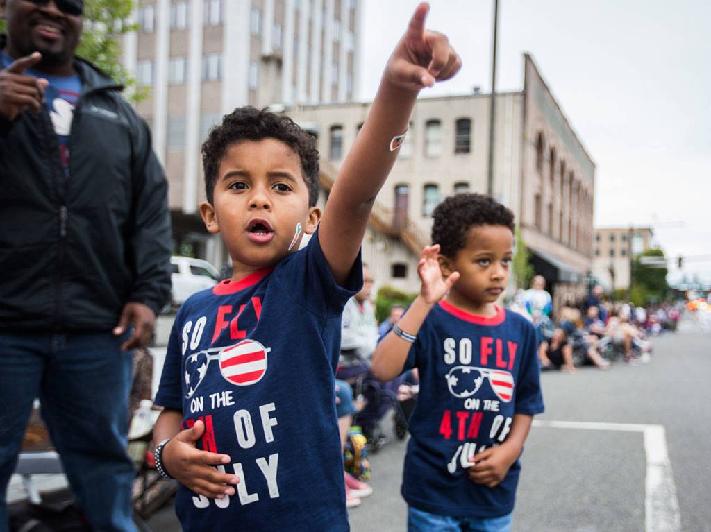 Micah West, 5, and Jaymen West, 5, react to a helicopter float July 4, 2019, during the Colors of Freedom Fourth of July Parade in Everett. (Olivia Vanni / The Herald)