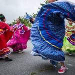 Baile Folklore Colibri members dance in the Everett High School parking lot July 4, 2019, before the start of the Colors of Freedom Fourth of July Parade in Everett. (Olivia Vanni / The Herald)