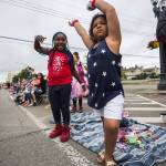 Gabrielle Jernigan (left) and cousin Dallas Minnifield dance July 4, 2019, during the Colors of Freedom Fourth of July Parade in Everett. (Olivia Vanni / The Herald)