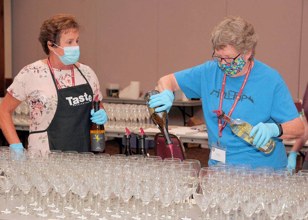 Helen Moir of Chesaw (center) pours a flight of white wine with Lori White (left), of Umatilla, Oregon, and Loris Stupel of Spokane preparing for the next phase at the 2020 Cascadia International Wine Competition in Lewiston, Idaho. (Richard Duval Images)