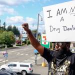 Elton Davis salutes on a rooftop as part of a weekly protest. Hes been charged with a misdemeanor for noise and public nuisance. (Kevin Clark / The Herald)