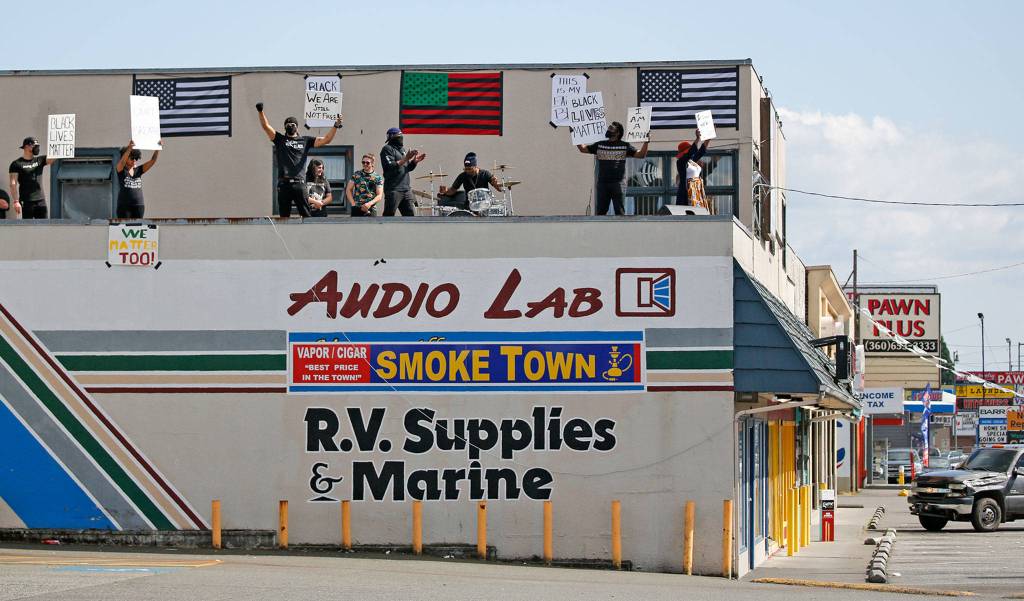 Protesters gather every week on a Marysville rooftop to bring awareness to police brutality. (Kevin Clark / The Herald)