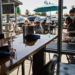 Madison Bauer, who has worked for Bluewater for more than 3 years, busses a table Friday in Everett. (Olivia Vanni / The Herald)