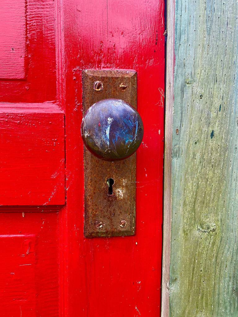 The knob on the red door turns but the door doesnt open. Many people try. (Andrea Brown / The Herald)