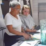 Seattle artist Barbara Earl Thomas and Treehouse participant Ericka work together on an art project Ericka graduated from high school this year and plans to finish her associates degree at Bellevue College and transfer to a university to study to become a youth advocate lawyer. (Treehouse)