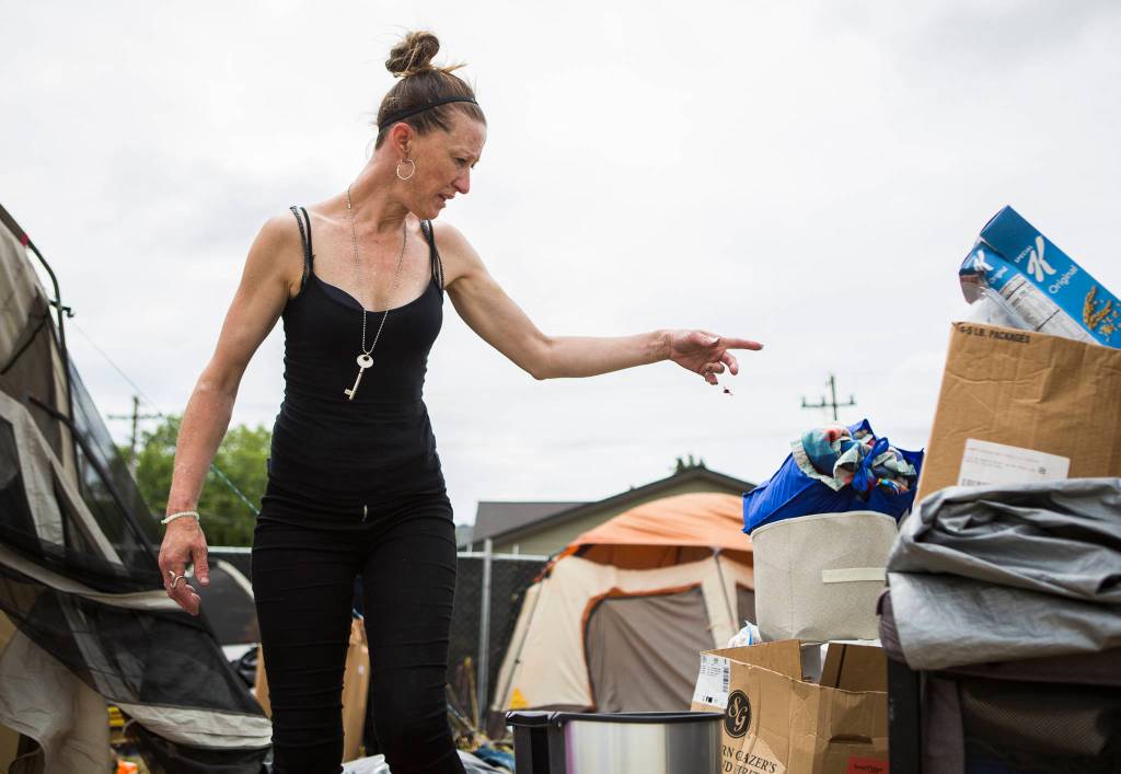 Kimberly Bailey organizes her belongings as she packs to leave her camp on Thursday in Everett. (Olivia Vanni / The Herald)