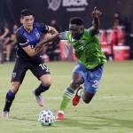Sounders defender Yeimar Gomez Andrade (right) battles for possession of the ball with Earthquakes forward Cristian Espinoza (10) during the second half of an MLS match July 10, 2020, in Kissimmee, Fla. (AP Photo/John Raoux)