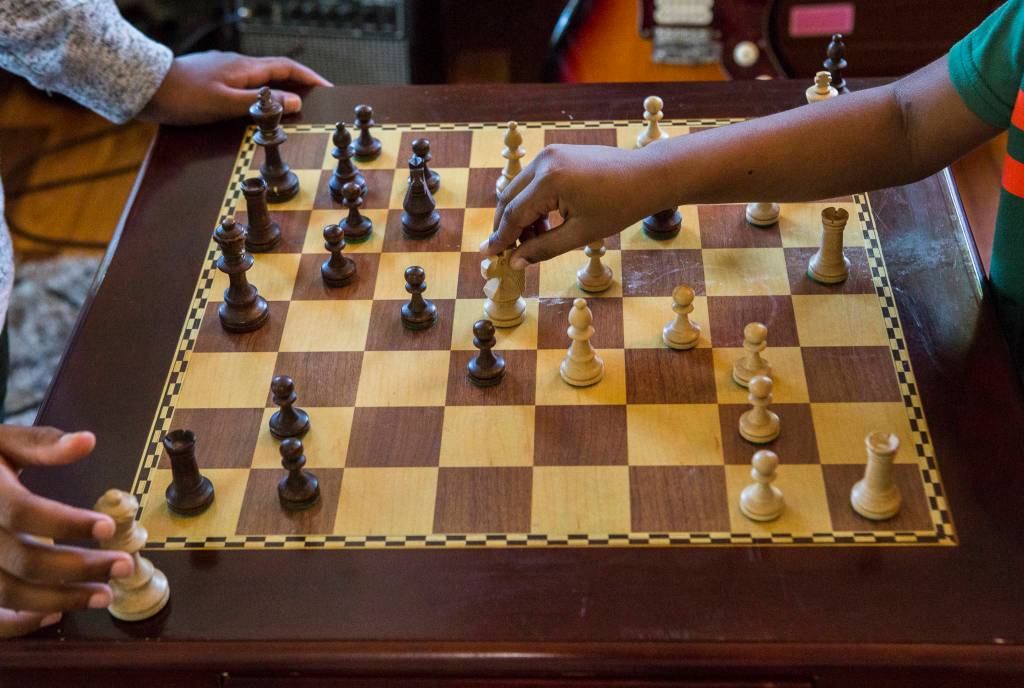 Keshav Beegala, 9, and his brother Dhruv, 6,play a practice chess match in Bothell. (Olivia Vanni / The Herald)