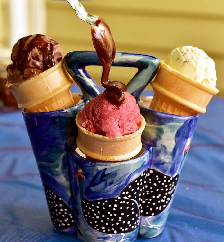 Nutella fudge sauce can be crowned with sprinkles, pretzels or pistachios and served with a variety of ice creams, like chocolate, hibiscus-rhubarb sorbet and banana ice creams pictured here. (Lucy Schaly / Pittsburgh Post-Gazette)