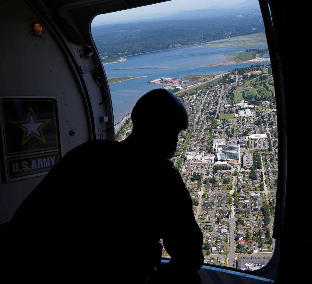 A member of the U.S. Army Golden Knights looks at the landing site at Providence Regional Medical Center. (Andy Bronson / The Herald)