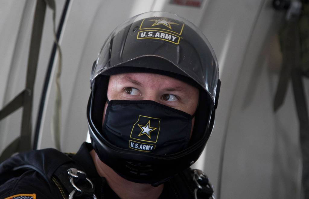 Wearing a mask under his helmet, Houston Creech and the rest of the U.S.Army Golden Knights gets ready to parachute into Everett. (Andy Bronson / The Herald)