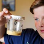 Skyler Jefferson, 10, has a summer science assignment: logging butterfly development at his home in Marysville. (Kevin Clark / The Herald)