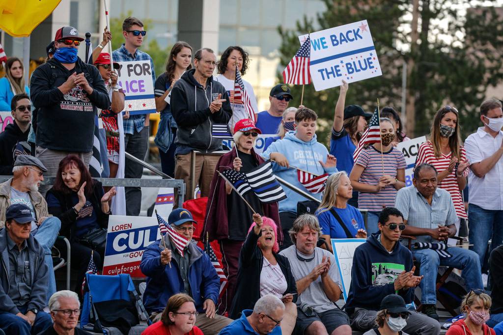Supporters cheer during the law enforcement and first responders rally sponsored by The Outreach Committee of the Snohomish County Republican Party Friday at the Snohomish County Plaza in Everett on July 17, 2020. (Kevin Clark / The Herald)