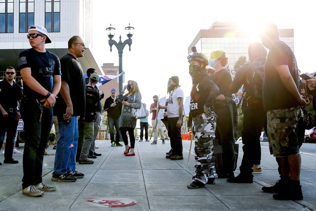 Supporters of law enforcement and first responders rally confront counter protesters Friday at the Snohomish County Plaza in Everett on July 17, 2020. (Kevin Clark / The Herald)