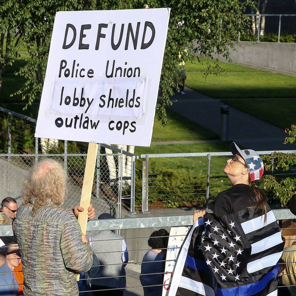 A protester attends the rally to support to law enforcement and first responders sponsored by The Outreach Committee of the Snohomish County Republican Party Friday at the Snohomish County Plaza in Everett on July 17, 2020. (Kevin Clark / The Herald)