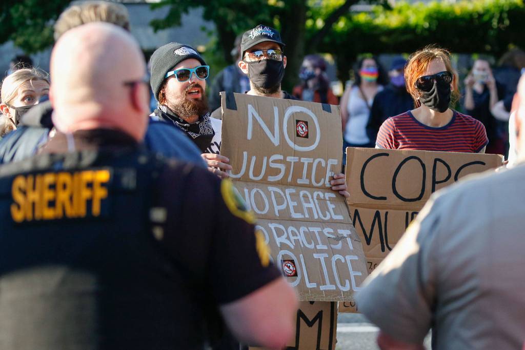 Protesters confront supporters of law enforcement and first responders rally Friday at the Snohomish County Plaza in Everett on July 17, 2020. (Kevin Clark / The Herald)