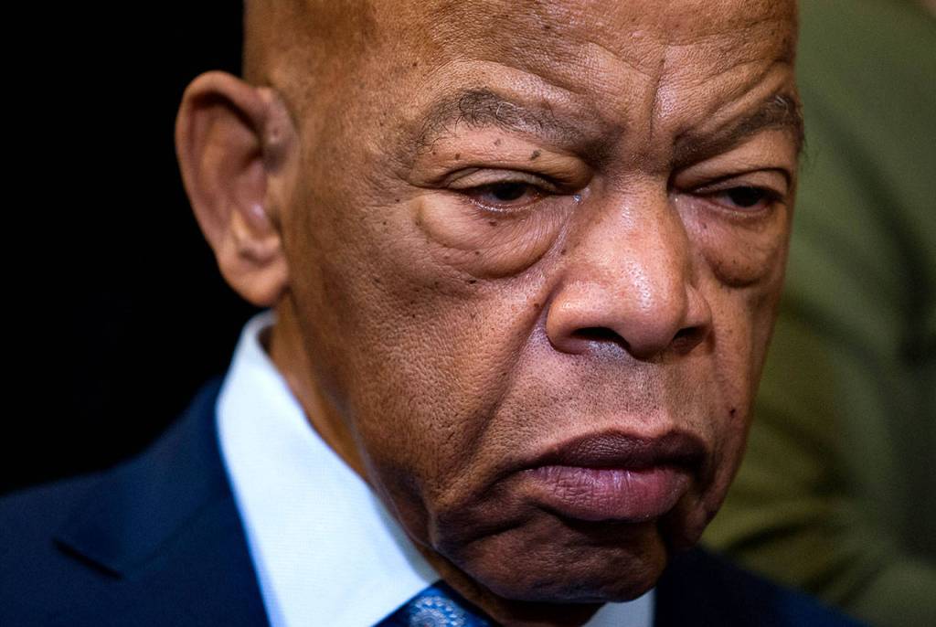 In this Dec. 6, 2019 photo, civil rights leader U.S. Rep. John Lewis, D-Ga., is extolled at an event with fellow Democrats before passing the Voting Rights Advancement Act to eliminate potential state and local voter suppression laws, at the Capitol in Washington. (AP Photo/J. Scott Applewhite, File)