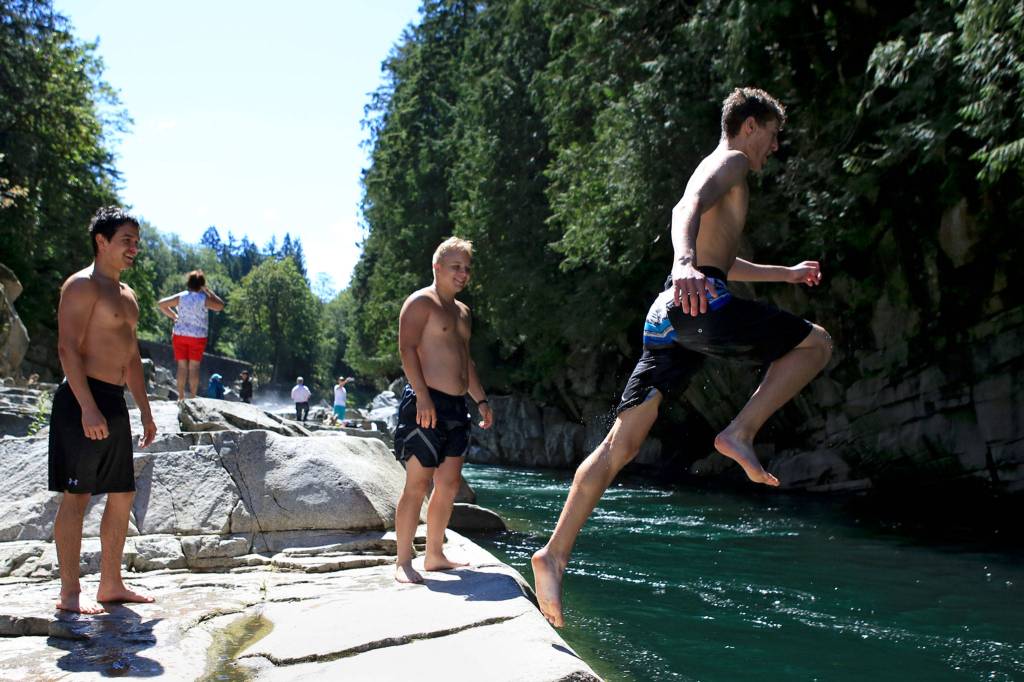 Johnny Marcello jumps into the swimming hole at Eagle Falls on July 14, 2016, just outside Index. (Kevin Clark / Herald file)