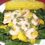 Florentine Shrimp Mango Salad with Sweet Corn on the Cob. (Linda Gassenheimer/TNS)