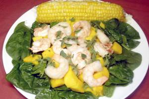 Florentine Shrimp Mango Salad with Sweet Corn on the Cob. (Linda Gassenheimer/TNS)