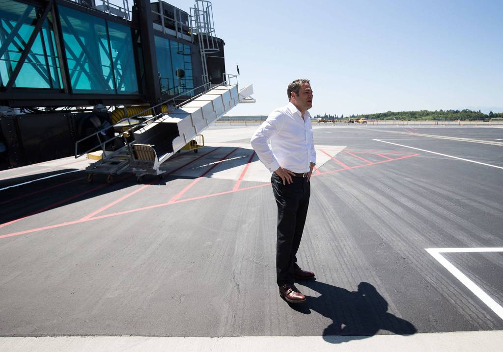 Brett Smith, CEO of Propeller Airports, talks about the new ramp at Paine Field Terminal. (Andy Bronson / The Herald)