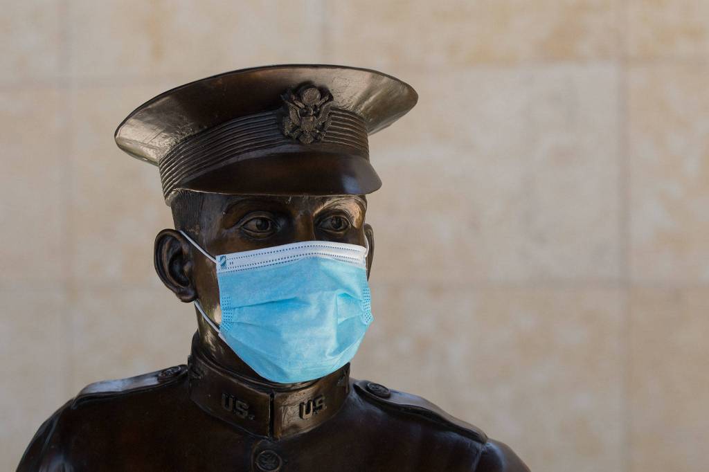 A statue of Paine Fields namesake, Everett native and commercial aviation pioneer Topliff Olin Paine, sports a mask at Paine Field Terminal. Masks will be required when the airport reopens to passenger service Saturday. (Andy Bronson / The Herald)