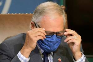 As virus surges, Inslee revives limits on restaurants, bars