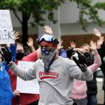 Carl Smith leads gathering protesters in a hands up, dont shoot chant May 31 in downtown Seattle. (AP Photo/Elaine Thompson, file)