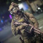A federal officer holds a tear gas rifle during a Black Lives Matter protest at the Mark O. Hatfield U.S. Courthouse early Sunday in Portland. (AP Photo/Marcio Jose Sanchez)