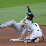Athletics second baseman Chad Pinder (18) falls on the Mariners J.P. Crawford after tagging Crawford out at second base on a stolen-base attempt during the fifth inning of a game Aug. 1, 2020, in Seattle. (AP Photo/Elaine Thompson)