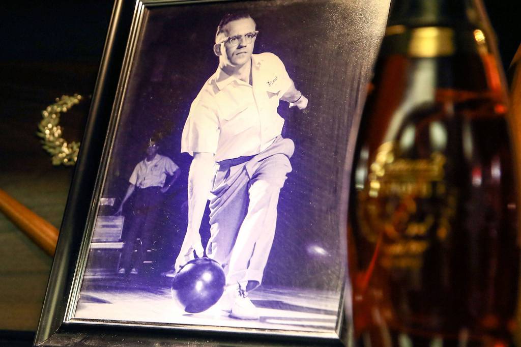 A photo of Ernie Miller, a pro bowler who died in 1999, graces the trophy case at Glacier Lanes bowling center. His sons, Steve and Larry Miller, now own the Everett business that announced its closure last week. (Kevin Clark / The Herald)