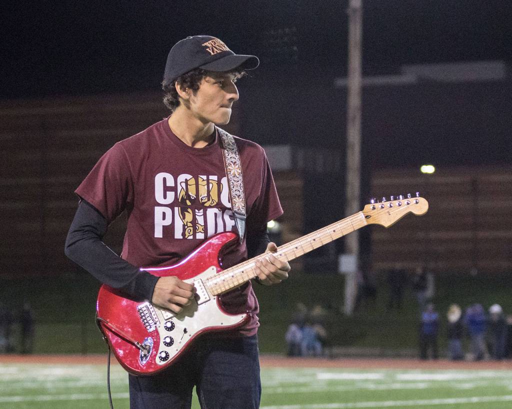 Lakewood senior Juan Corrales plays guitar with the pep band during halftime of the schools homecoming football game in 2019. (Matt Wright photo)