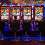 Slot machine players maintain social distances as the Tulalip Resort Casino reopened to the public, with social distancing rules and limited capacity, on May 26, on the Tulalip Reservation. (Andy Bronson / The Herald file photo)