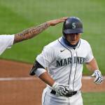 The Mariners Kyle Seager (right) is congratulated by J.P. Crawford after hitting a three-run home run during the third inning of a game against the Angels on Aug. 5, 2020, at T-Mobile Park in Seattle. (AP Photo/Elaine Thompson)
