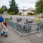 People walk by the new dining area outside of Cafe Zippy along Rucker Avenue on Thursday in Everett. Cafe Zippy is one of a handful of Everett businesses to apply for the new streatery program. (Olivia Vanni / The Herald)