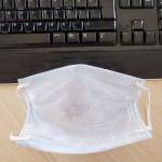 The mask of an employee who returned to the office during the normalization period after corona virus quarantine, stands in front of the keyboard. (Getty Images)