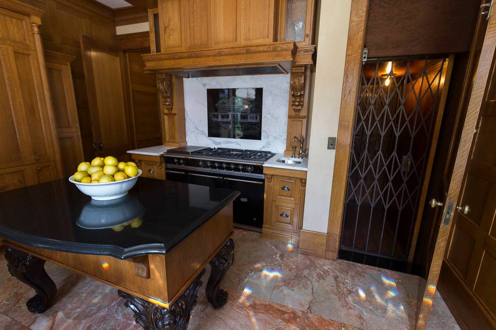 The kitchen in the Rucker Mansion sports an elevator and a marble-engraved backsplash of the house. (Andy Bronson / The Herald)